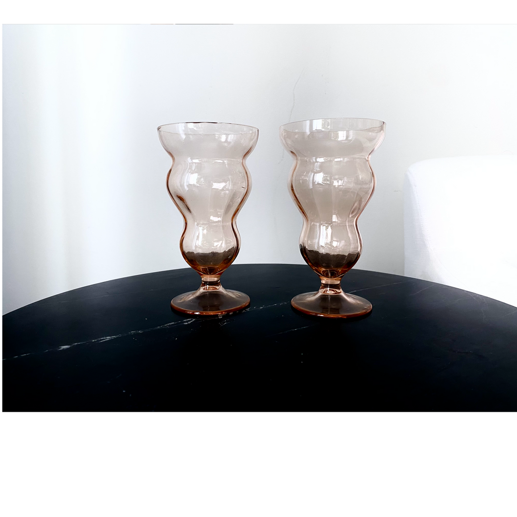 Vintage wavy glass goblet. Color is peachy blush. Hogan Parker is a contemporary luxury online shop for books, gifts, vintage wares, soap, jewelry, home decor, cookware, kitchenware, and more.