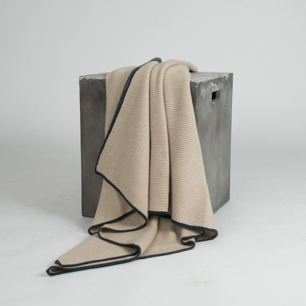 Blankets & Throws. Pique Cashmere Knit Throw. Beige with sage border. From Hangai Mountain Textiles. Hogan Parker is a new contemporary luxury online shop for books, thoughtful gifts, soap, jewelry, home decor, cookware, kitchenware, and more.