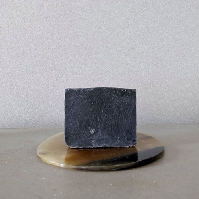 Charcoal handmade organic bar soap. Palm oil and sulfate free. In the Hogan Parker bath and body care collection. Hogan Parker is a contemporary and luxury online shop for books, gifts, vintage wares, soap, jewelry, home decor, cookware, kitchenware, and more. 